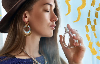Woman smelling perfume with gold details
