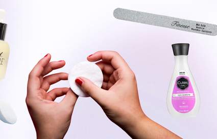 picture of someone's hands taking off nail polish with products around them