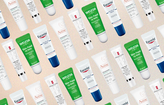 rows of diagonal lip balm tubes with a beige gradient background