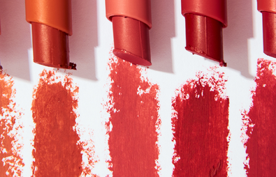 five lipsticks on white background