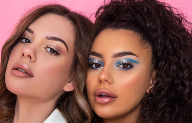 Two women looking at the camera with flawless makeup