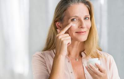 Mature woman applying face cream