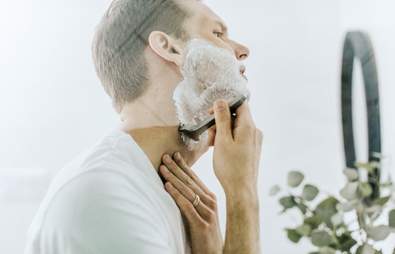 man shaving in mirror